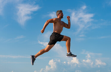 Runner man bare torso running. Sport and health. Man running against blue sky. Healthy lifestyle. Sportsman running in summer. Sport runner do workout. Sport lifestyle with morning run