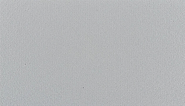 Subtle Texture in Grayscale: A close-up view of a muted grayscale surface reveals a fine, textured pattern, capturing the nuances of light and shadow. 