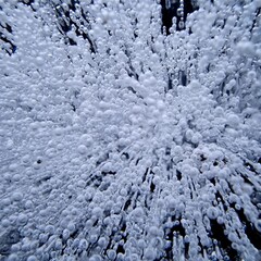 Frozen Air Bubbles Trapped in a Clear Ice Sheet Against a dark surface