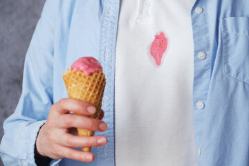 Dirty spilled pink strawberry stain on white clothes during a moment of enjoyment. Concept of daily...