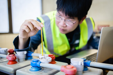 Technician inspects battery backup system with maintenance tool ensuring power reliability and...