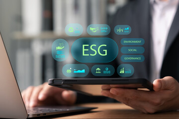 Businessman analyzing ESG data on digital tablet, focusing on environmental, social and governance factors for sustainable investment, corporate responsibility and ethical business strategy.