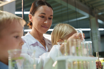 Kids and families have fun holding molecular models to learn about chemistry in the classroom,...