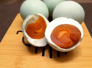 Salted eggs served on a wooden tray. Processed food made from duck eggs.