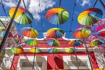 Street with a rainbow parasol in the Dominican Republic © Yumiko