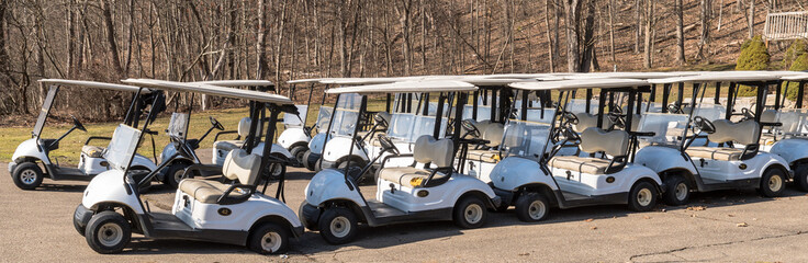 Golf carts lined up at a golf course in Oil City, Pennsylvania, USA on a sunny winter day