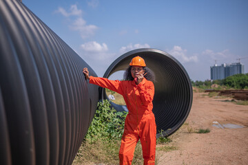 Construction surveyor or engineer working in pipe construction site for inspection detail of...