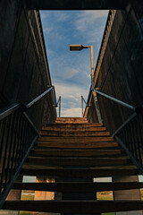 Concrete stairs leading to pedestrian walkway on Stockton Brigde with soft blue sky