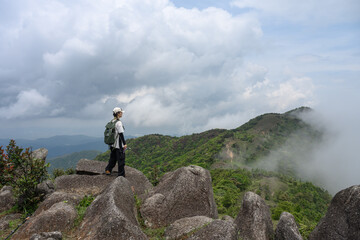 The woman standing alone on a mountaintop