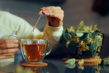 Person Puts Sweetener with Pipette into Tea Cup. Woman using sugar alternatives for sweetening herbal drinks 