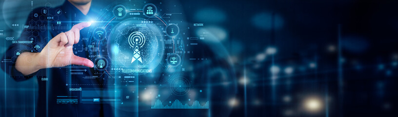 Businessman touching TELECOMMUNICATIONS icons symbolizes connectivity, innovation, network expansion, data exchange, digital communication, and global information flow in modern technology.