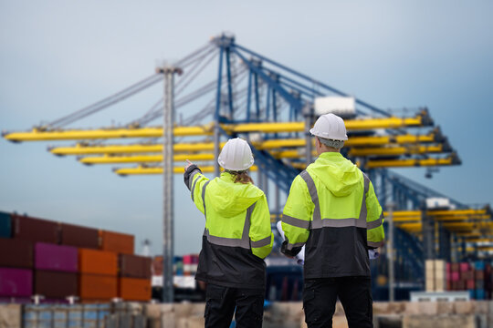 Industrial engineer workers operations marine port cranes loading and unloading of cargo ships global trade and supply chain import export environment monitoring responsible global economy.