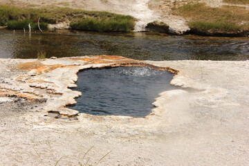 Hot spring bubbles in Yellowstone National Park showcase geological activity and natural beauty in vibrant colors