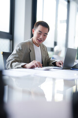 Attractive confident millennial Asian Business man using laptop computer and professional working investor start up project business planning in office.