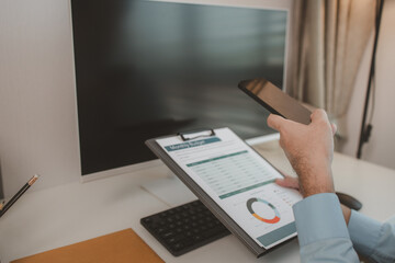 an entrepreneur is working diligently in an office, a businessman is using a smartphone to take a photo of a document, the manager is reviewing a document, marketing, company, accountant