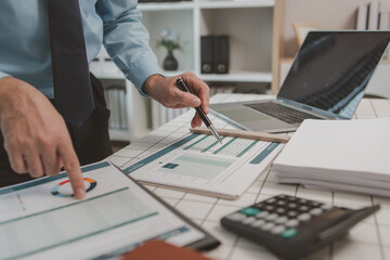 the chief accountant is working hard to check the documents and financial figures to be in accordance with the disbursement report, a businessman is sitting in his private office, calculate, company