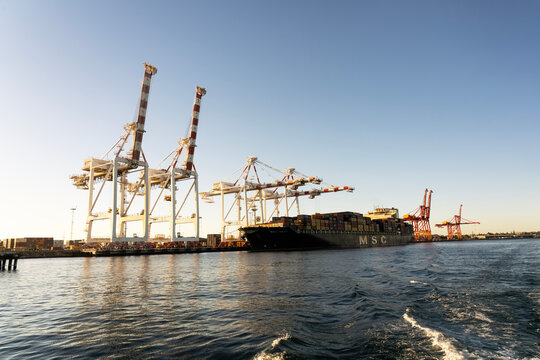 Ship loading cranes or derricks  in Freemantle harbour, Western Australia with a freighter ship ready to depart.