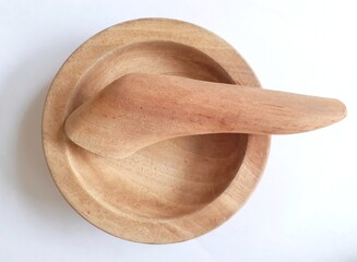 Mortar and pestle made of ordinary wood for making chili sauce and spices isolated on white...
