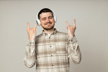 Attractive young guy listening to music in headphones