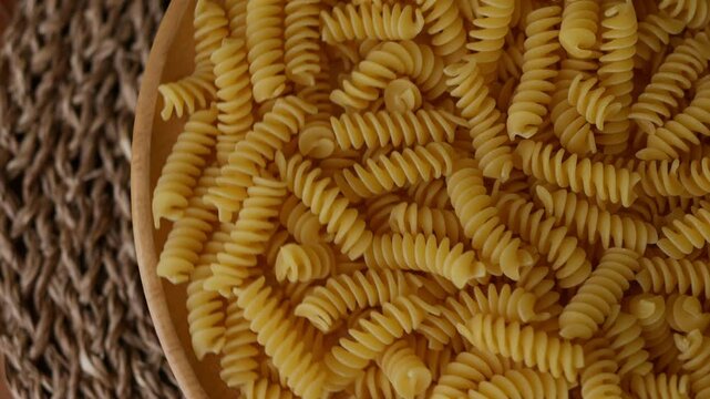 Raw Fusilli Spiral spaghetti pasta pattern background.