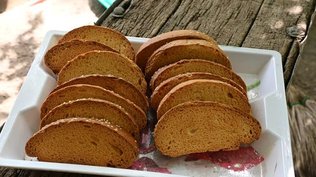 Crispy rusk, Biscuits cake rusk over wooden background , a crunchy snack infused with traditional spices, perfect for tea or coffee. A delightful treat for your mornings or tea time