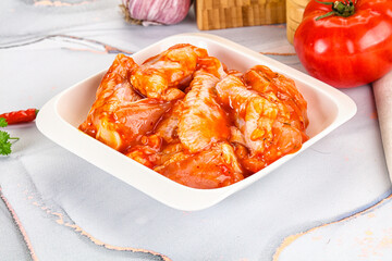 Raw marinated uncooked chicken wings
