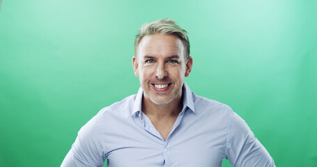 Fototapeta premium Mature, portrait and happy businessman with positive attitude on a green studio background. Man, executive or model with smile in confidence for job opportunity or business career on mockup space