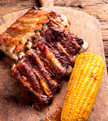 Pork ribs with corn and sauce.