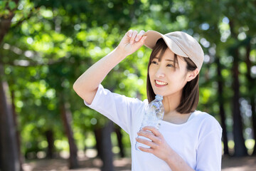 公園で水分補給する女性