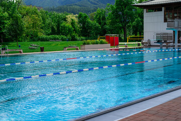 View of the surface of blue water in a public outdoor swimming pool in park