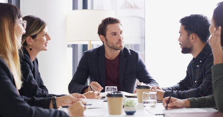 Man, group and meeting with talking at startup with agenda, listen or strategy at media company. People, journalist and editor with collaboration, review or team with feedback for project at agency