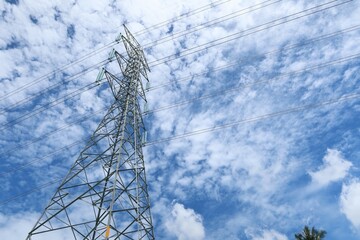 high voltage tower against blue sky