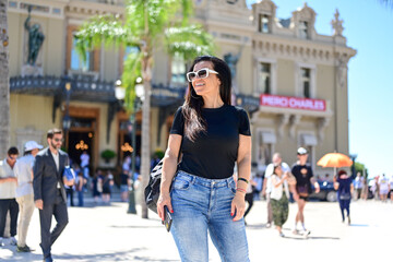 Portrait of happy    smiling   woman at Monaco . Casual portrait outdoors, tourist in  Monte Carlo  Brunette woman  near the Casino of Monte Carlo