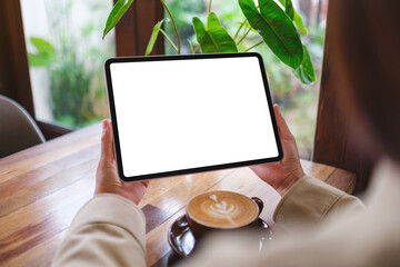 Mockup image of a woman holding digital tablet with blank white desktop screen