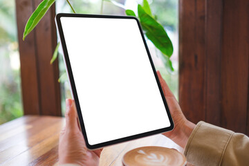 Mockup image of a woman holding digital tablet with blank white desktop screen