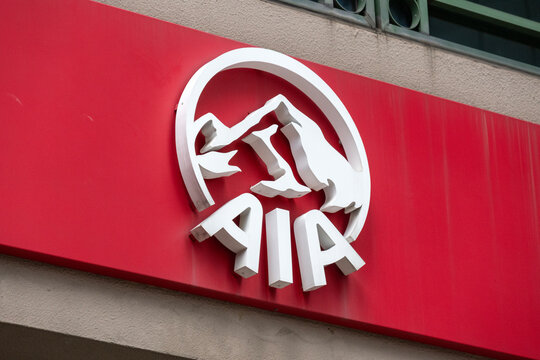 Sign of AIA insurance company on the facade of building in Singapore.