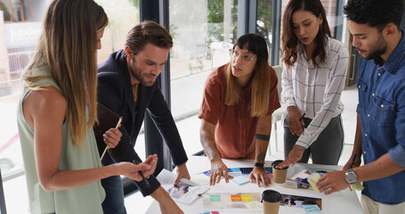 Group, creative business people and discussion with document for brand strategist. Team meeting, manager and collaboration in startup office for planning, proposal and strategy for ad campaign design