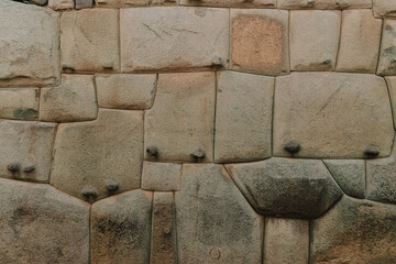 Close-up view of an ancient Inca stone wall on a traditional cobblestone street in Cusco, Peru 3
