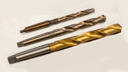Three twist drills of different diameters with titanium nitride coating and Morse shank.