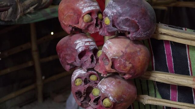 Aghori post-mortem ceremony ritual skulls inside aghori shelter tilt up, Varanasi, India 
