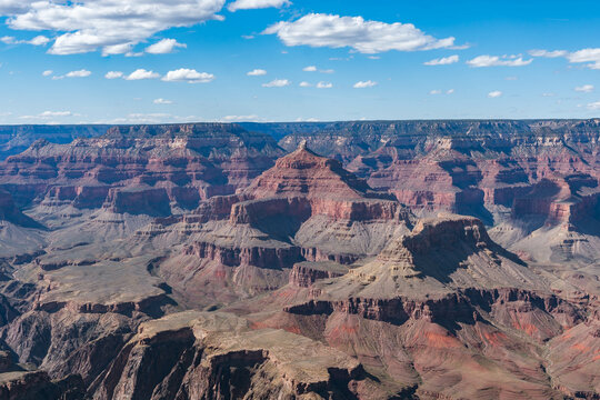 Panoramic views of the Grand Canyon, Arizona, USA, showcasing the dramatic landscape, layered rock formations, and vivid colors under a clear sky. Perfect for travel and nature themes.