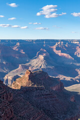Panoramic views of the Grand Canyon, Arizona, USA, showcasing the dramatic landscape, layered rock formations, and vivid colors under a clear sky. Perfect for travel and nature themes.