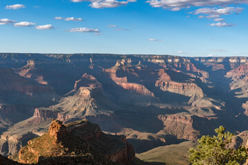 Panoramic views of the Grand Canyon, Arizona, USA, showcasing the dramatic landscape, layered rock formations, and vivid colors under a clear sky. Perfect for travel and nature themes.