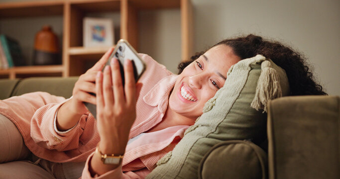 Woman, relax and excited on sofa for phone, online chat and match on dating website with contact. Home, female person and happiness with mobile for app, friend request or notification on social media