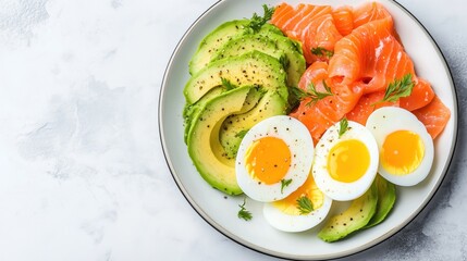 Colorful keto-friendly breakfast plate featuring fresh avocado and salmon slices