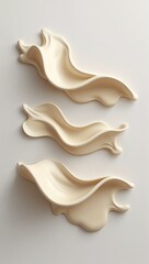 Three Creamy Beige Liquid Splash Shapes in Triangular Layout on White Background with Fluid Motion