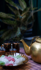 Sweet "pleret" cakes and cups and teapots of Traditional Indonesian Tea