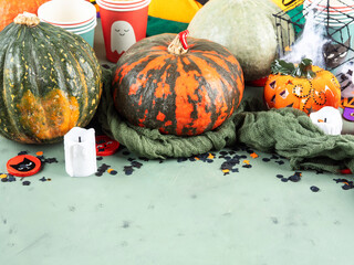 Halloween party setting with pumpkins, candies and decor