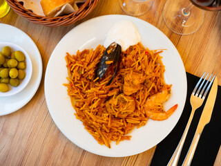 Coastal restaurant treats guests to mix seafood chicken pasta made from durum wheat pasta and...