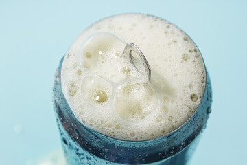Open aluminum can with foam close up. Cold refreshing drink
